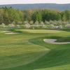A spring view of green protected by bunkers at Orchard Creek Golf Club